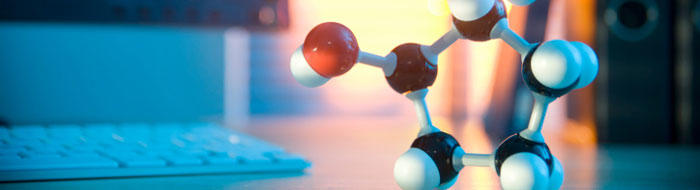 A modal of a molecule on a desk next to a keyboard